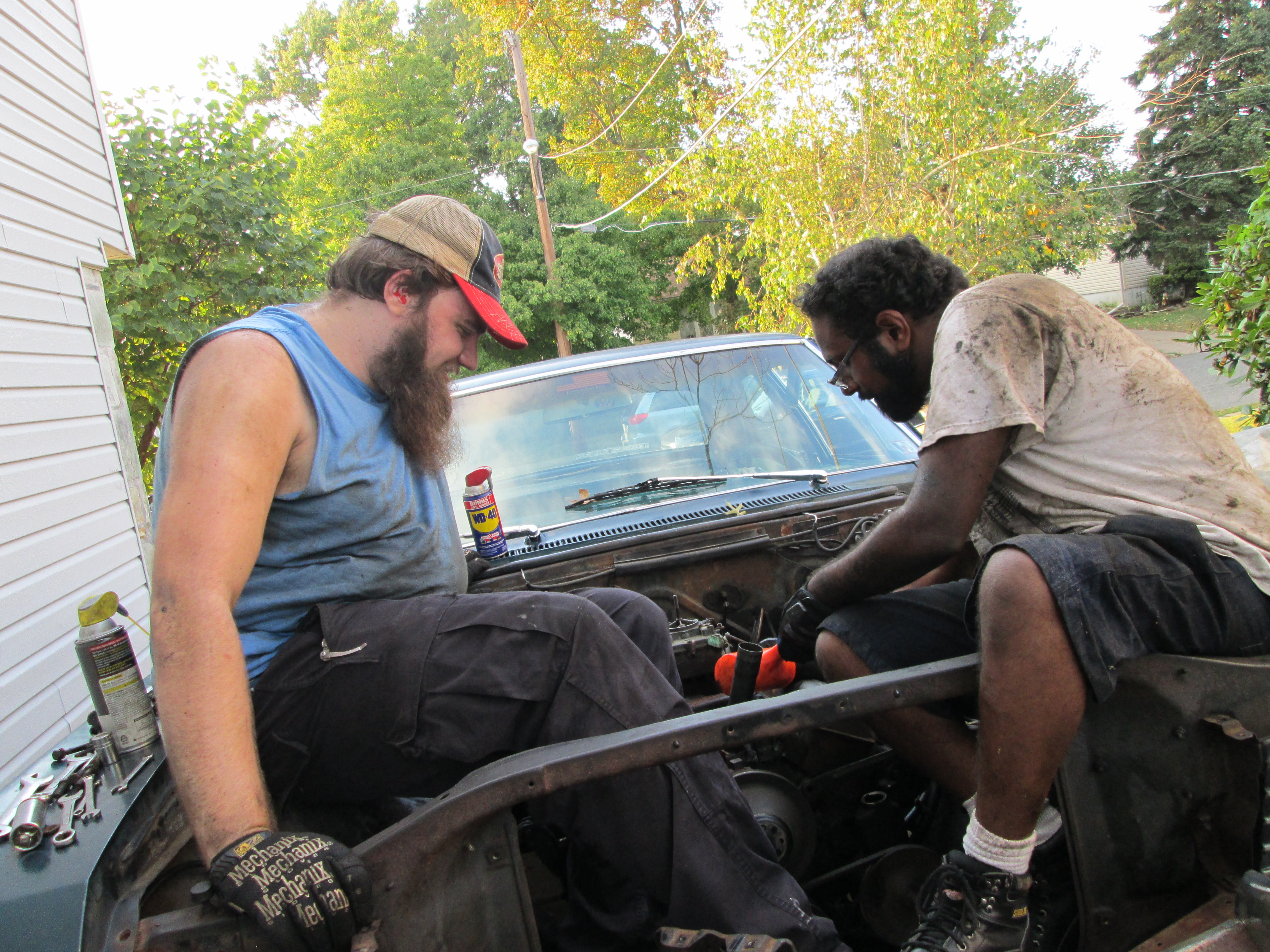 Derek and Stephen work to get the spark plug distributor out